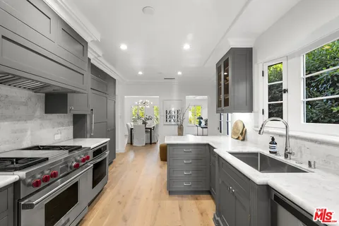 a kitchen with stainless steel appliances granite countertop a stove and a sink
