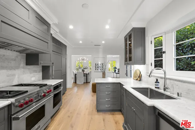 a kitchen with stainless steel appliances granite countertop a stove and a sink