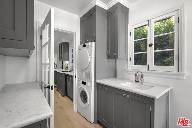 a bathroom with a sink a washer and dryer
