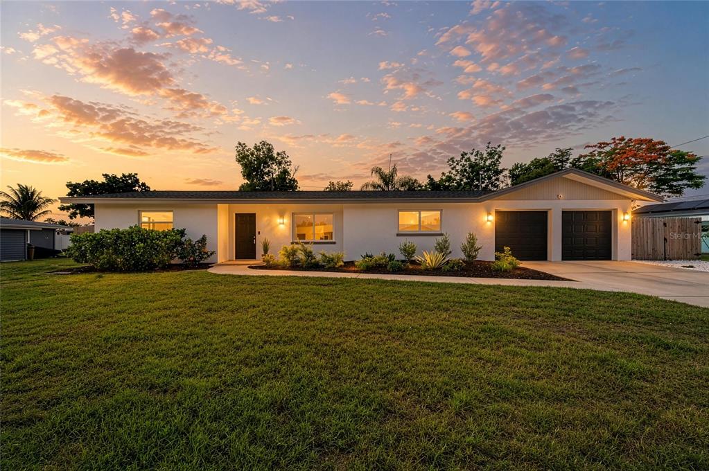 2544 Orsova Way Sarasota, FL 34231 - Photo 1 of 39 a front view of house with an outdoor space and seating