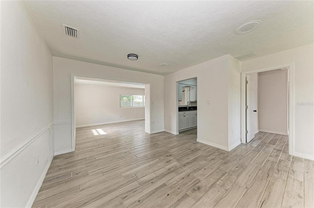 2544 Orsova Way Sarasota, FL 34231 - Photo 14 of 39 wooden floor in an empty room with a window