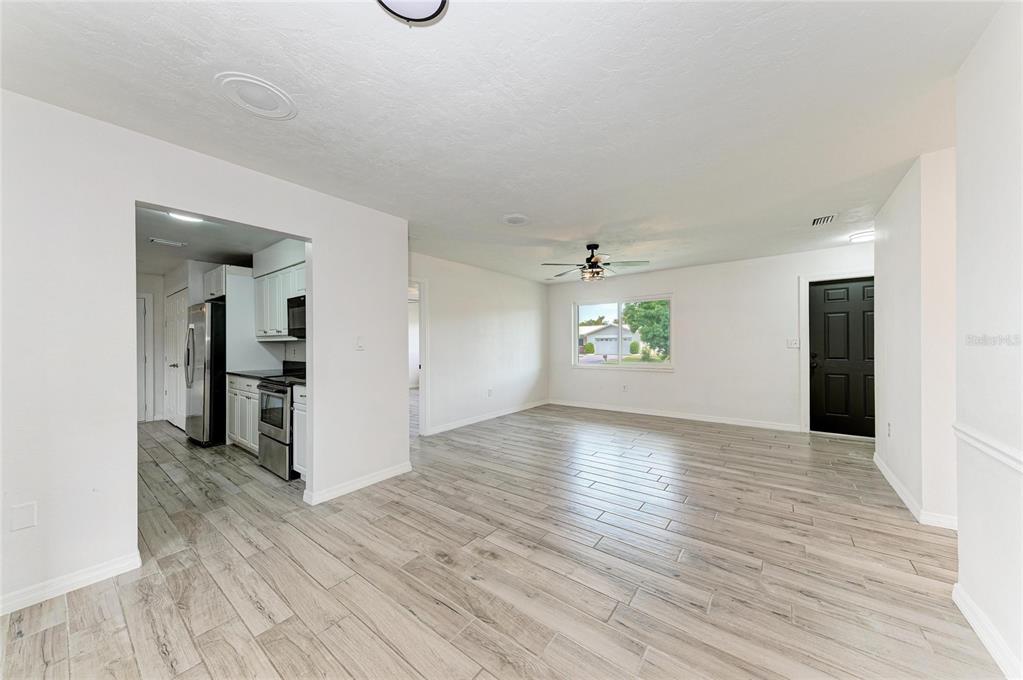 2544 Orsova Way Sarasota, FL 34231 - Photo 15 of 39 wooden floor in an empty room with a window