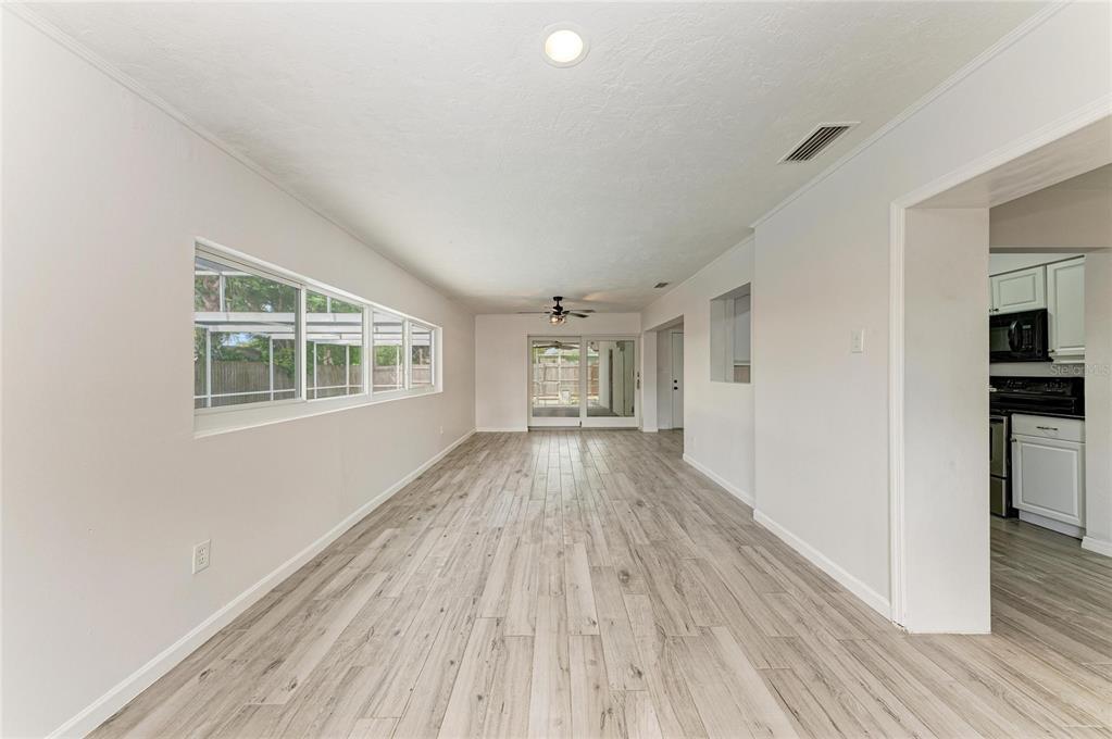 2544 Orsova Way Sarasota, FL 34231 - Photo 16 of 39 a view of empty room with wooden floor and fan
