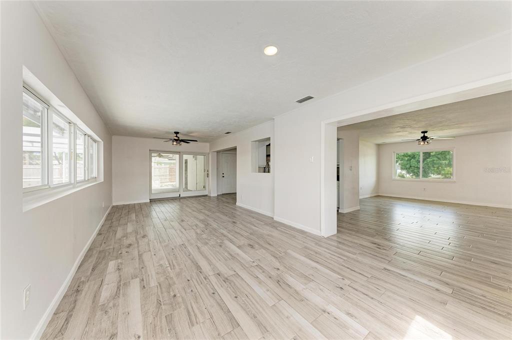 2544 Orsova Way Sarasota, FL 34231 - Photo 17 of 39 wooden floor in an empty room with a window