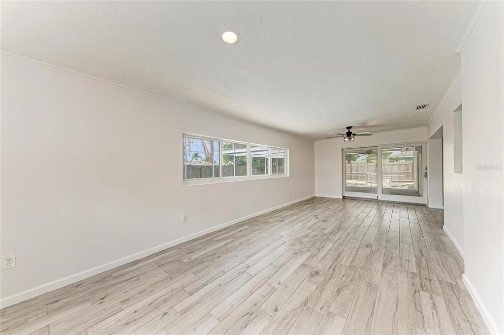 2544 Orsova Way Sarasota, FL 34231 - Photo 18 of 39 wooden floor in an empty room with a window