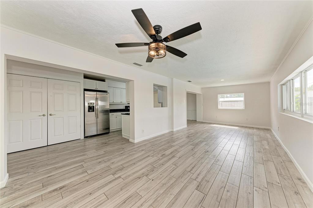 2544 Orsova Way Sarasota, FL 34231 - Photo 19 of 39 a view of empty room with wooden floor and ceiling fan