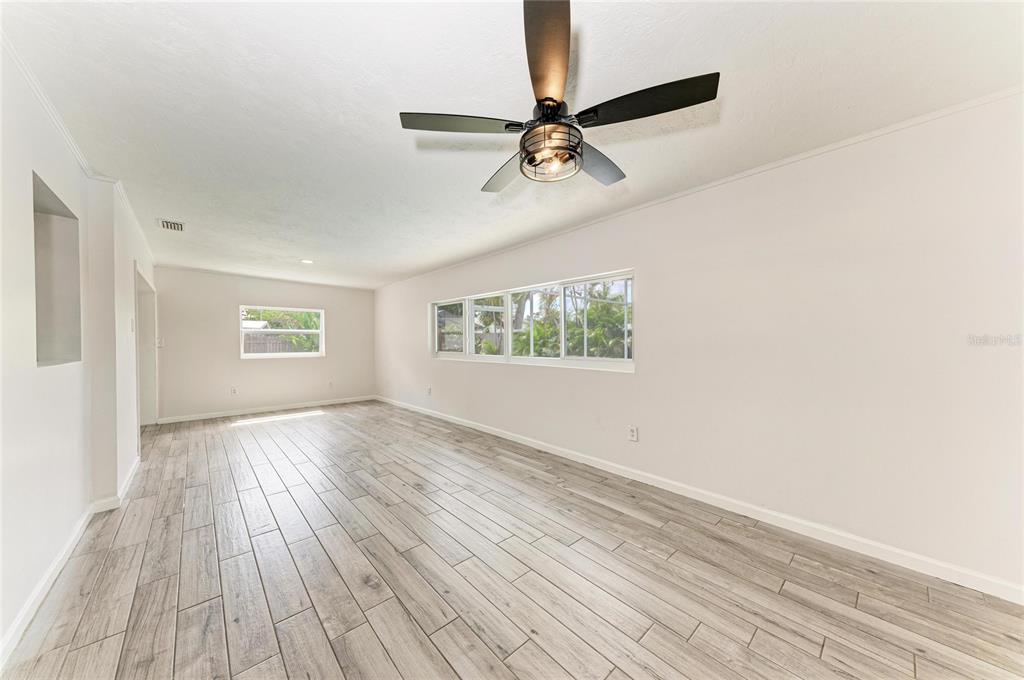 2544 Orsova Way Sarasota, FL 34231 - Photo 20 of 39 wooden floor in an empty room with a window