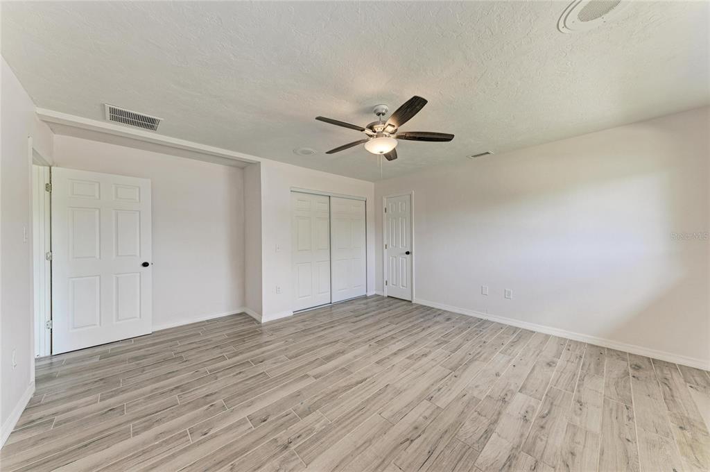 2544 Orsova Way Sarasota, FL 34231 - Photo 22 of 39 a view of an empty room with wooden floor