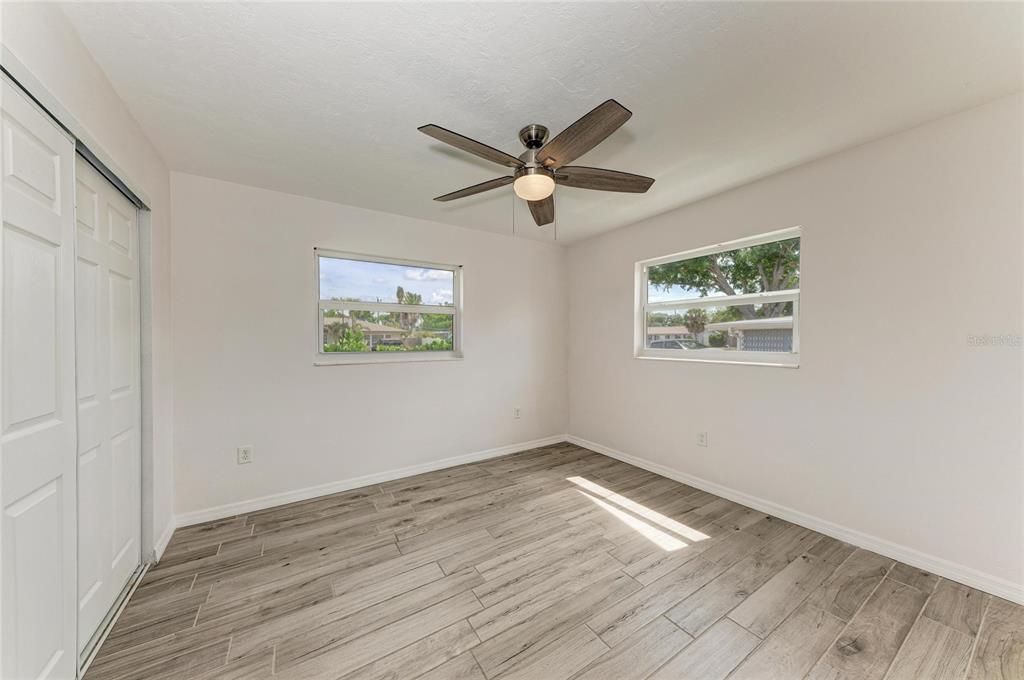 2544 Orsova Way Sarasota, FL 34231 - Photo 26 of 39 a view of empty room with wooden floor