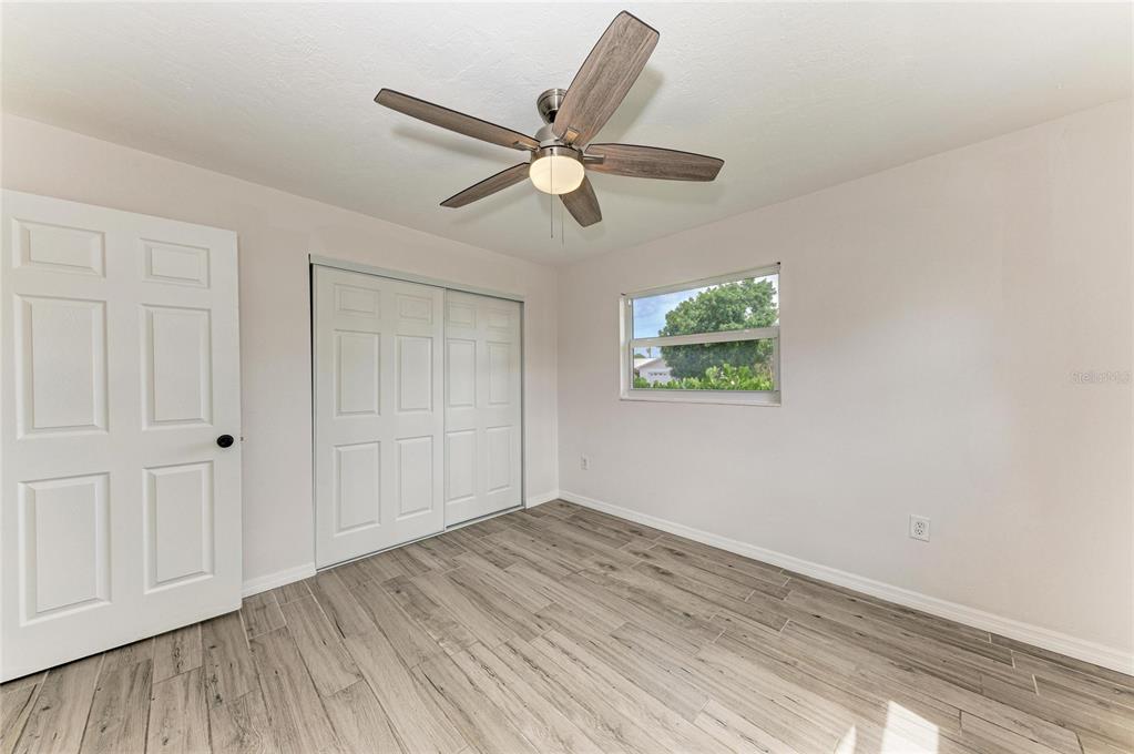 2544 Orsova Way Sarasota, FL 34231 - Photo 27 of 39 wooden floor in an empty room with a window