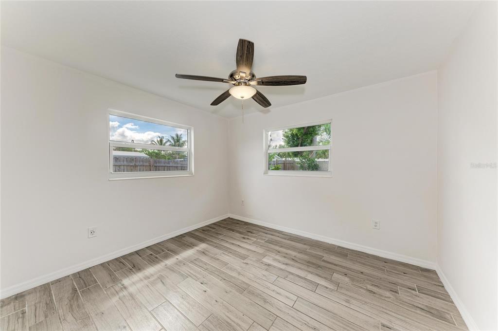 2544 Orsova Way Sarasota, FL 34231 - Photo 28 of 39 a view of empty room with wooden floor