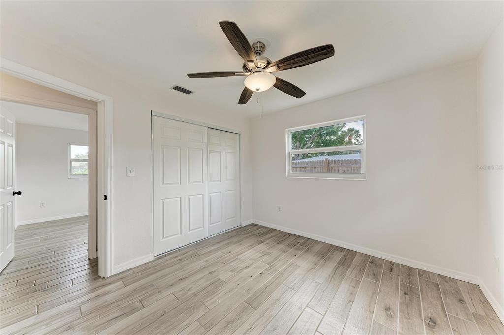 2544 Orsova Way Sarasota, FL 34231 - Photo 29 of 39 a view of empty room with wooden floor and fan