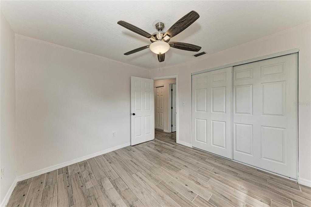 2544 Orsova Way Sarasota, FL 34231 - Photo 30 of 39 a view of an empty room with wooden floor