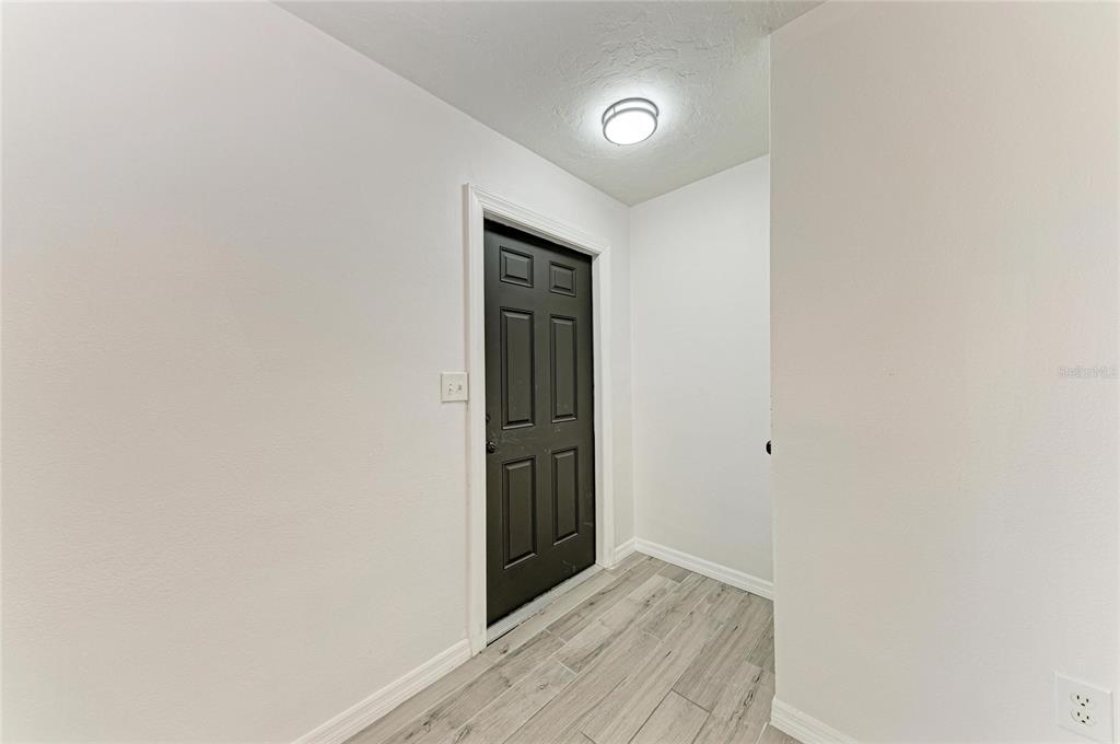 2544 Orsova Way Sarasota, FL 34231 - Photo 3 of 39 a view of an empty room with wooden floor