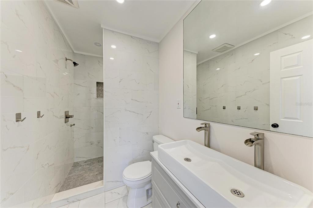 2544 Orsova Way Sarasota, FL 34231 - Photo 31 of 39 a bathroom with a toilet sink and shower