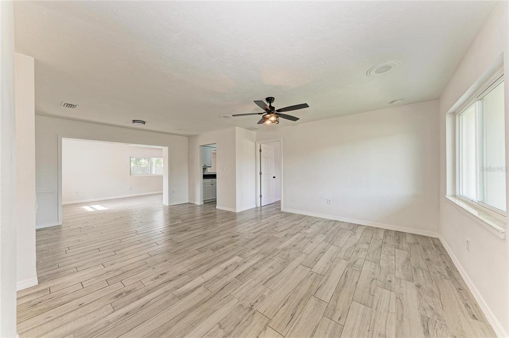 2544 Orsova Way Sarasota, FL 34231 - Photo 4 of 39 a view of empty room with wooden floor and fan