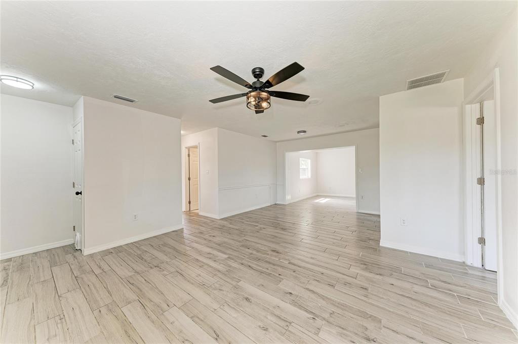 2544 Orsova Way Sarasota, FL 34231 - Photo 5 of 39 a view of empty room with wooden floor and fan