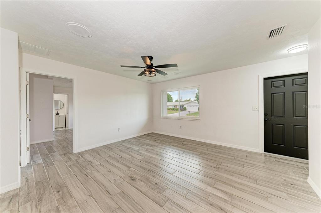 2544 Orsova Way Sarasota, FL 34231 - Photo 6 of 39 wooden floor in an empty room with a window