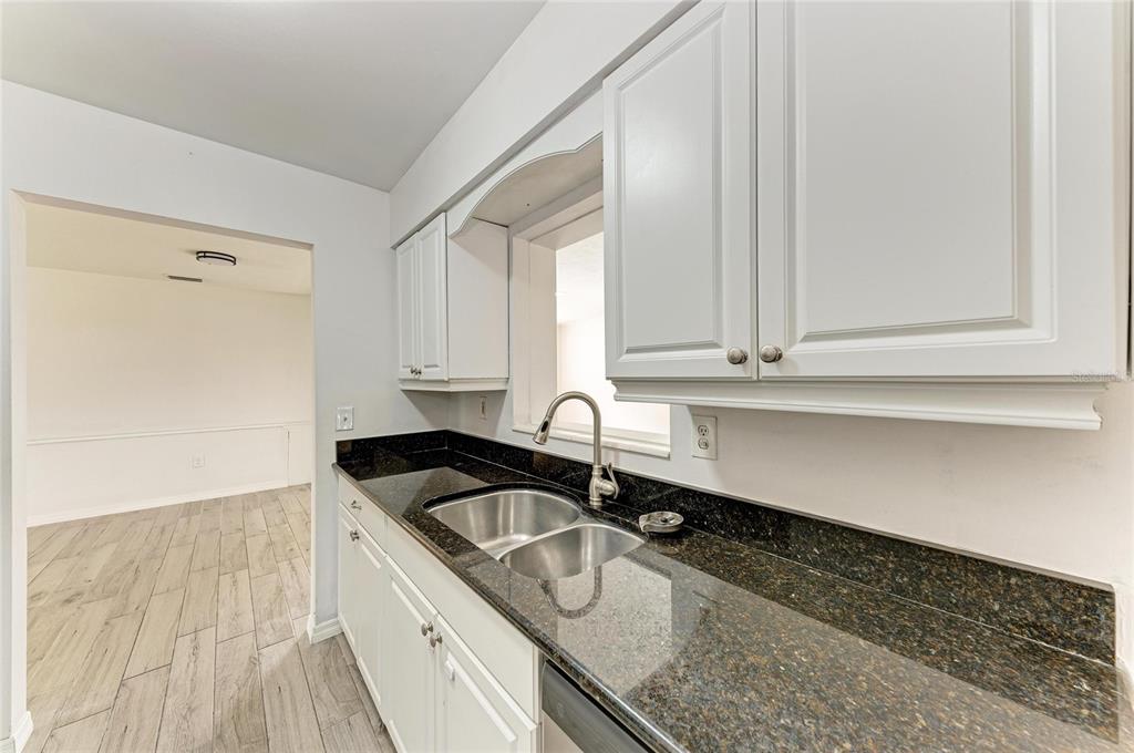 2544 Orsova Way Sarasota, FL 34231 - Photo 10 of 39 a kitchen with granite countertop a sink and cabinets