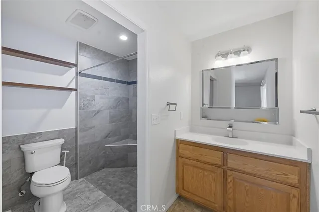 a kitchen with a table chairs refrigerator and cabinets