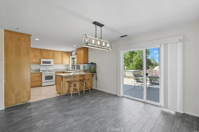 an empty room with windows and fireplace