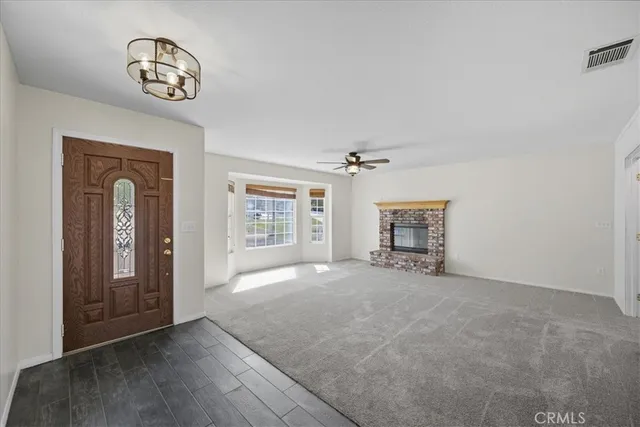 an empty room with windows and cabinet