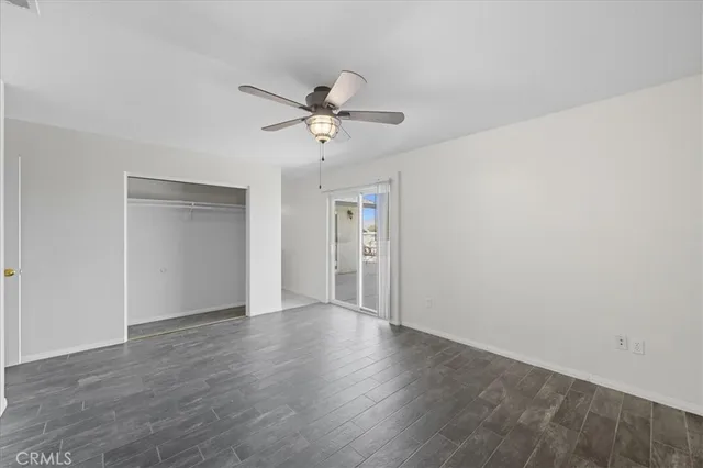 a view of a big room with wooden floor and windows in a room