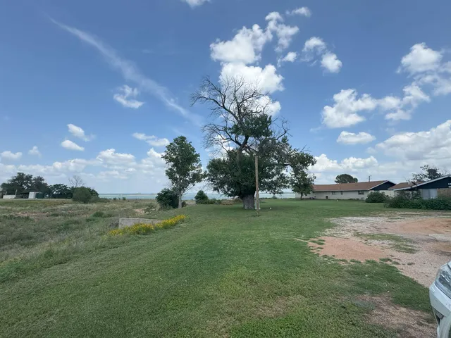 a view of a big yard with a house