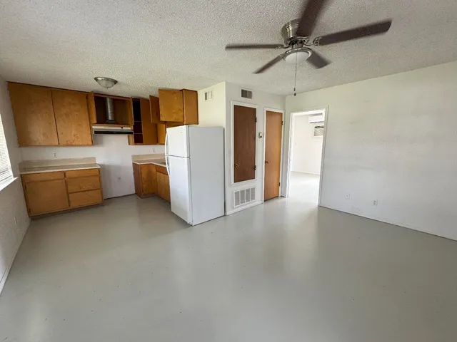 a view of a kitchen with furniture and a ceiling fan