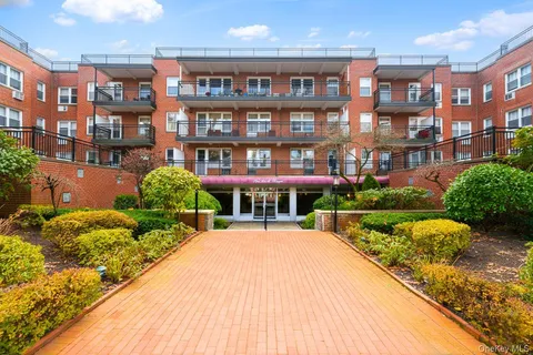 a view of a brick building next to a yard