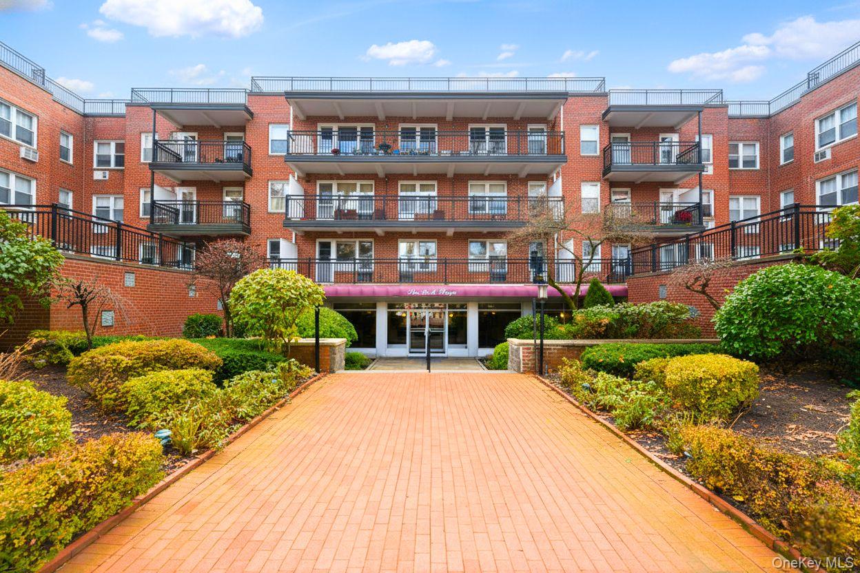 30 Stoner Avenue, Unit 1S Great Neck, NY 11021 - Photo 1 of 29 a view of a brick building next to a yard