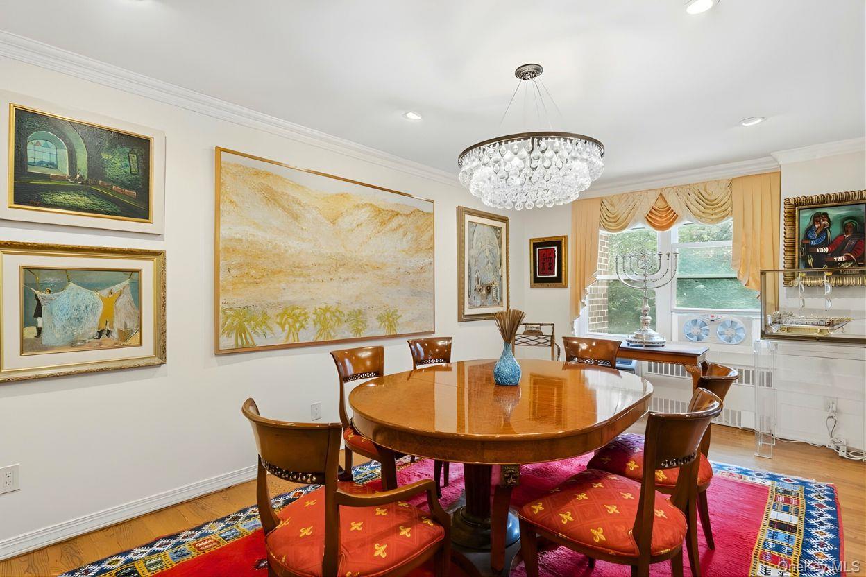 30 Stoner Avenue, Unit 1S Great Neck, NY 11021 - Photo 11 of 29 a dining room with furniture a large window and wooden floor