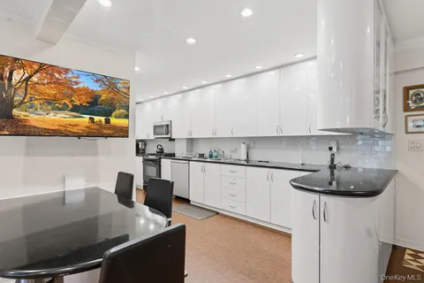 a kitchen with stainless steel appliances granite countertop a sink and a stove