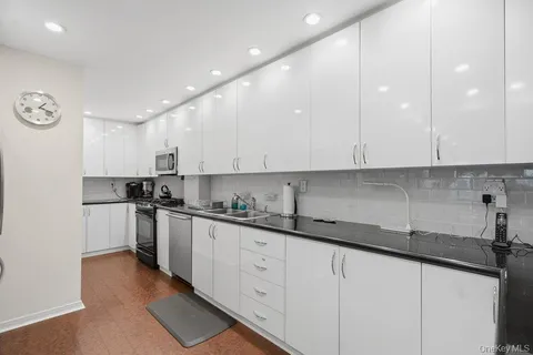 a kitchen with stainless steel appliances granite countertop a sink and cabinets