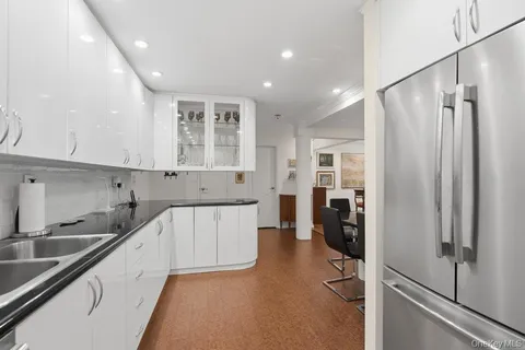a kitchen with a sink cabinets and refrigerator