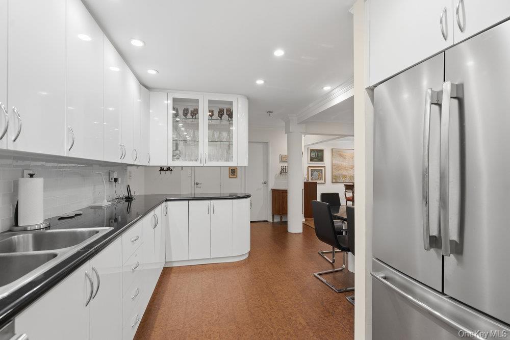 30 Stoner Avenue, Unit 1S Great Neck, NY 11021 - Photo 16 of 29 a kitchen with a sink cabinets and refrigerator