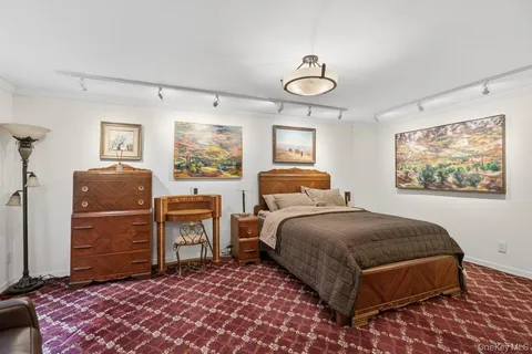 a bedroom with a bed and dresser with mirror