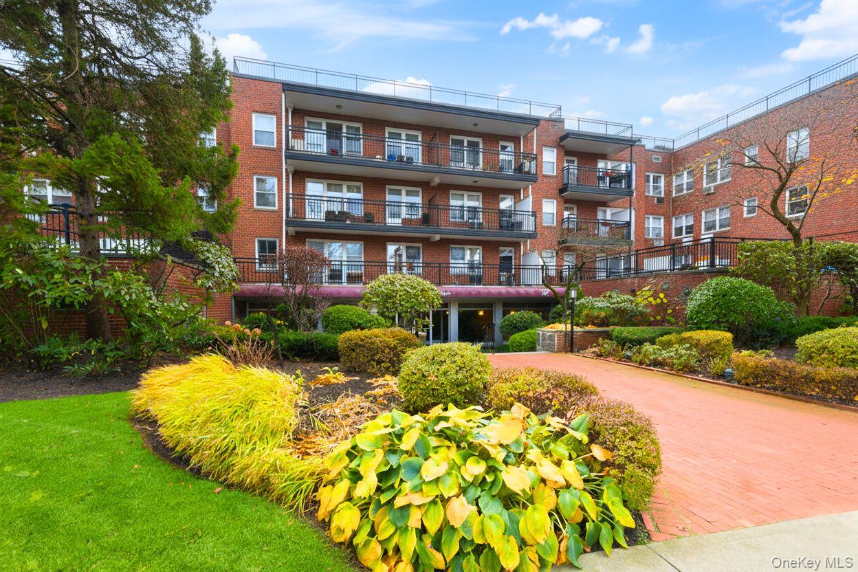 30 Stoner Avenue, Unit 1S Great Neck, NY 11021 - Photo 2 of 29 a view of a house with a yard and potted plants
