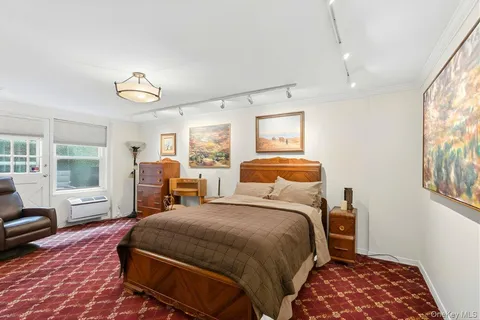 a bedroom with bed and wooden floor