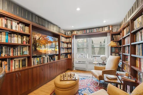 a living room with furniture and a book shelf