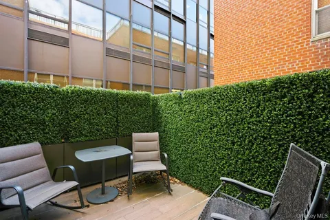 a view of a chair and table in backyard