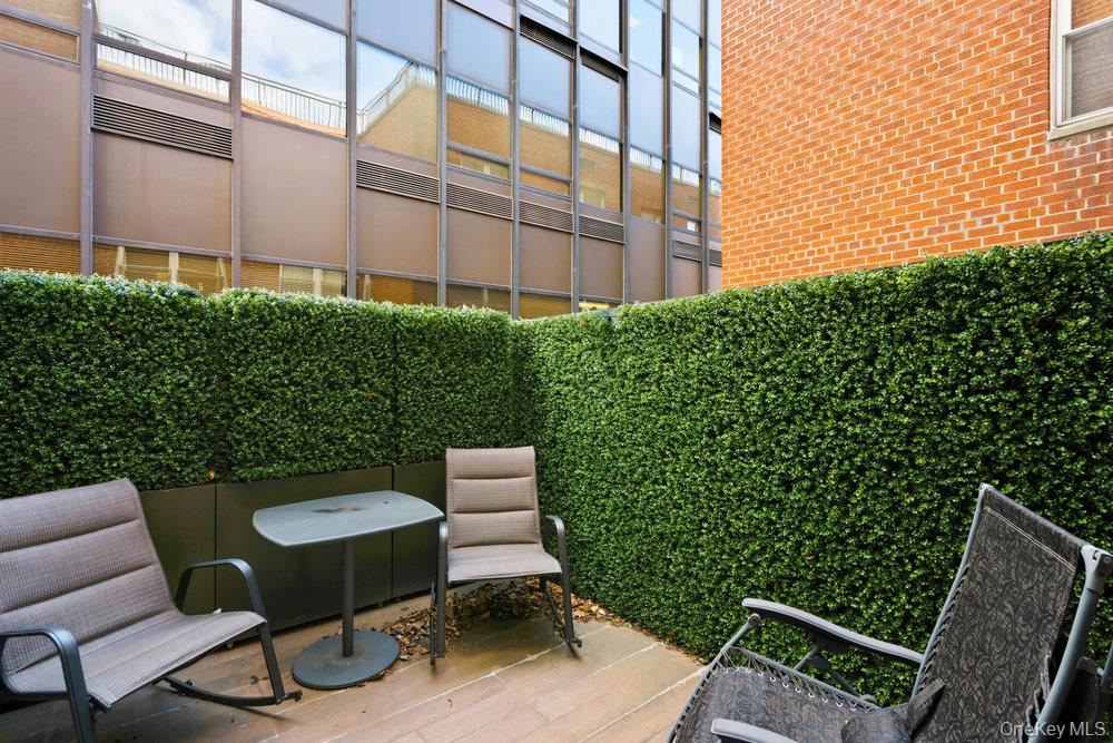 30 Stoner Avenue, Unit 1S Great Neck, NY 11021 - Photo 27 of 29 a view of a chair and table in backyard