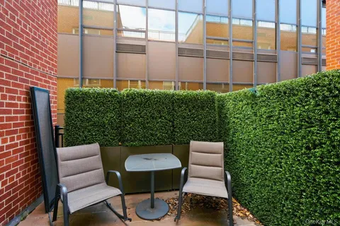 a view of a chair and table in backyard