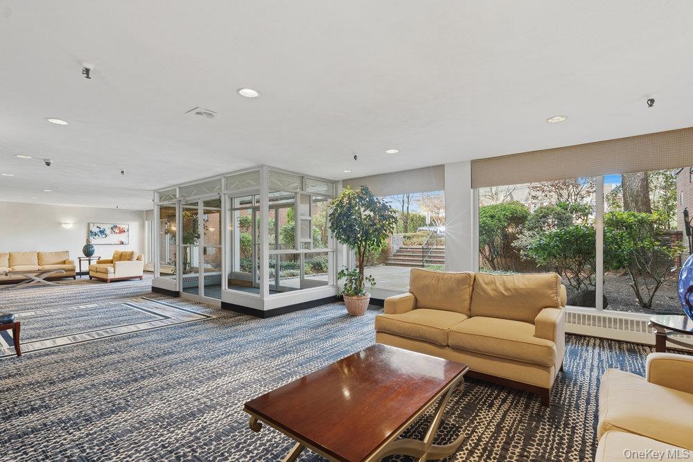 30 Stoner Avenue, Unit 1S Great Neck, NY 11021 - Photo 4 of 29 a living room with furniture and a table