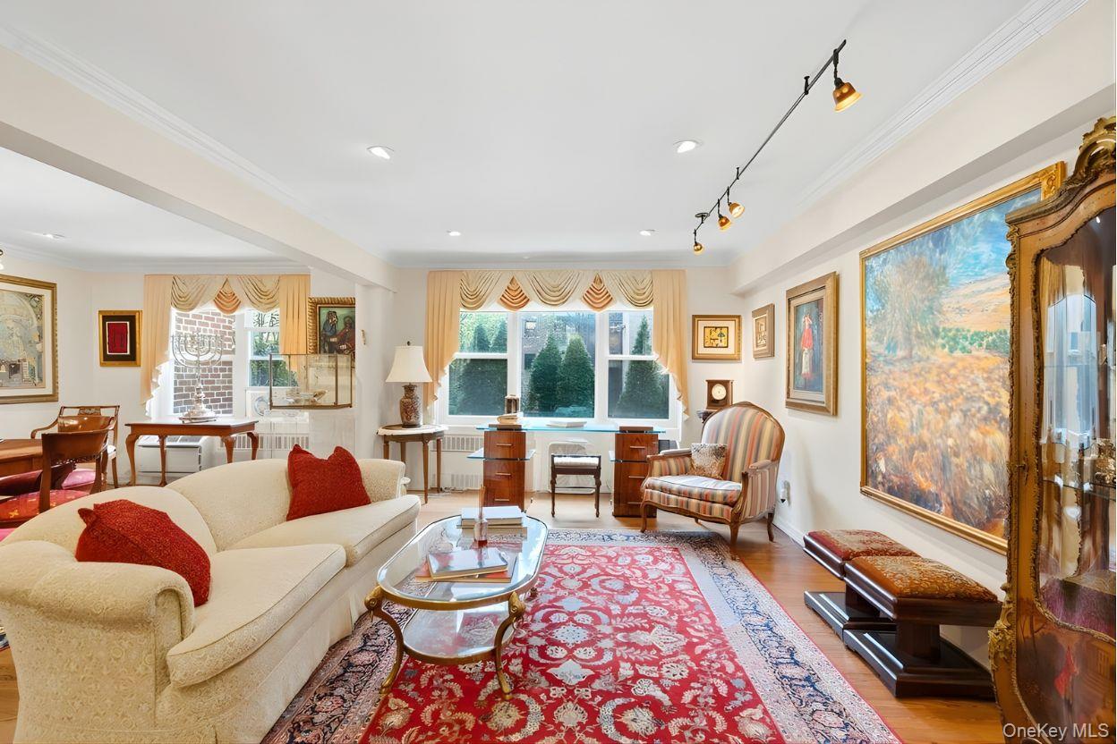 30 Stoner Avenue, Unit 1S Great Neck, NY 11021 - Photo 5 of 29 a living room with furniture and a large window
