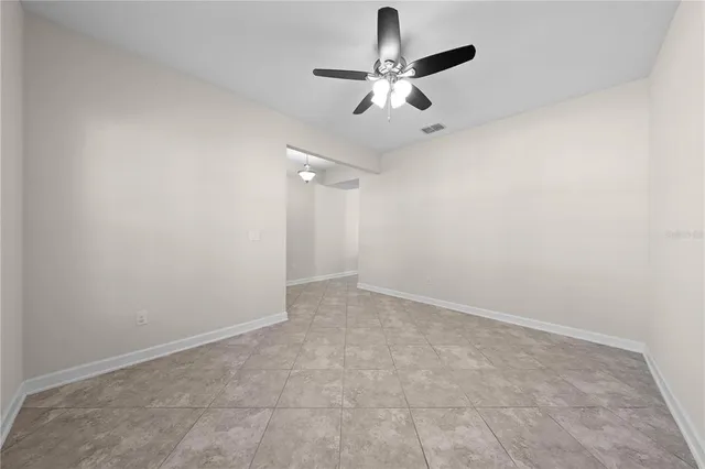 a view of a backyard with a garden and chairs