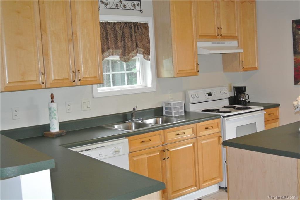 454 Gilmer Edwards Road Rutherfordton, NC 28139 - Photo 6 of 21 a kitchen with stainless steel appliances granite countertop white cabinets and a sink