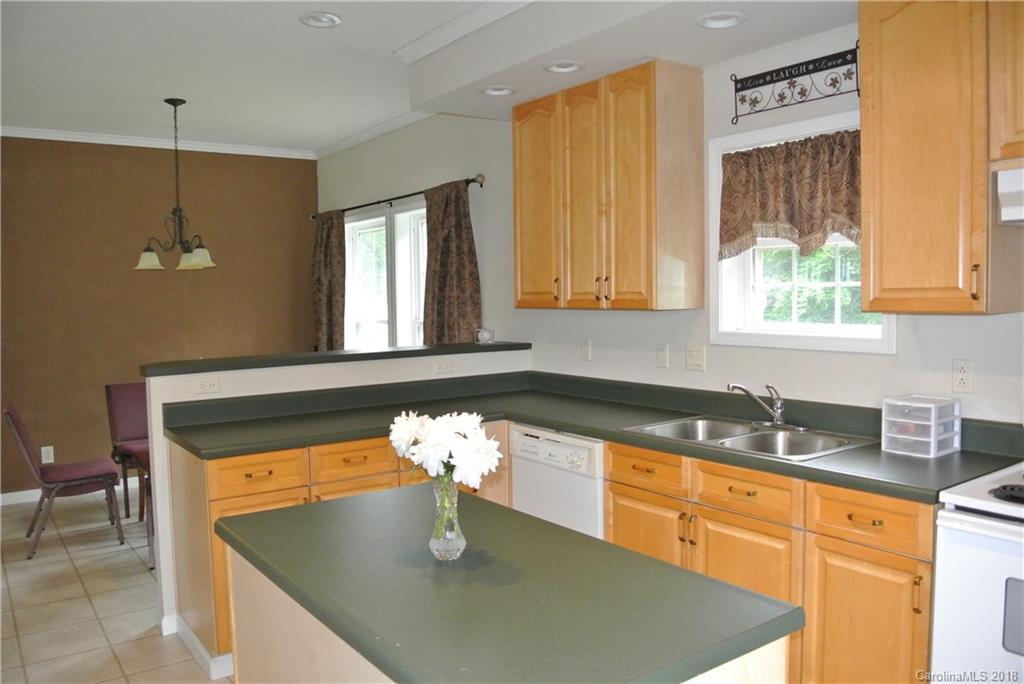 454 Gilmer Edwards Road Rutherfordton, NC 28139 - Photo 7 of 21 a kitchen with stainless steel appliances granite countertop a sink a window and dining table