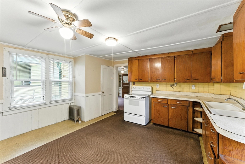 112 Grape Street Chicopee, MA 01013 - Photo 15 of 42 a view of a kitchen with a sink and cabinet with wooden floor