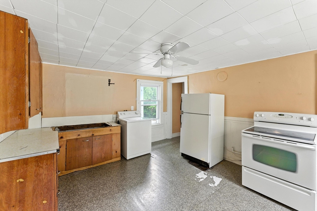 112 Grape Street Chicopee, MA 01013 - Photo 31 of 42 a kitchen with a stove top oven sink and refrigerator